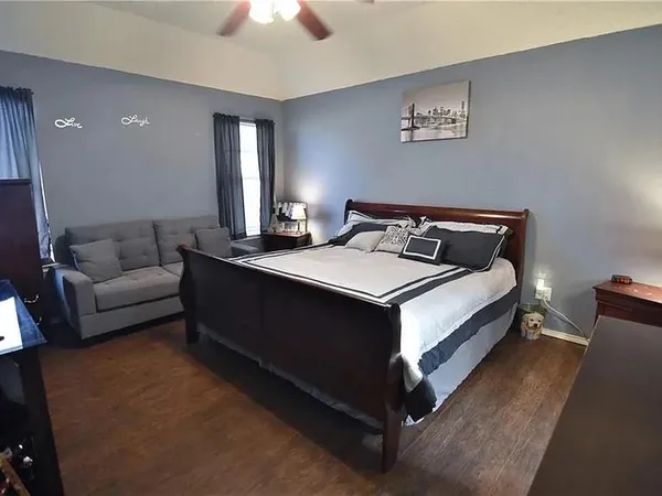 a bedroom with a bed and a couch