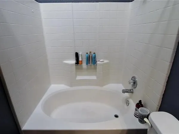 a white bath tub sitting in a bathroom