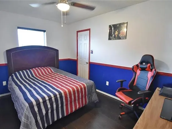 a bedroom with a bed and a chandelier