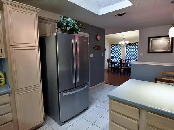 a kitchen with refrigerator and cabinets