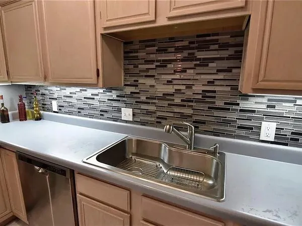 a kitchen with a sink and cabinets