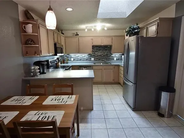 a kitchen with a sink cabinets and refrigerator