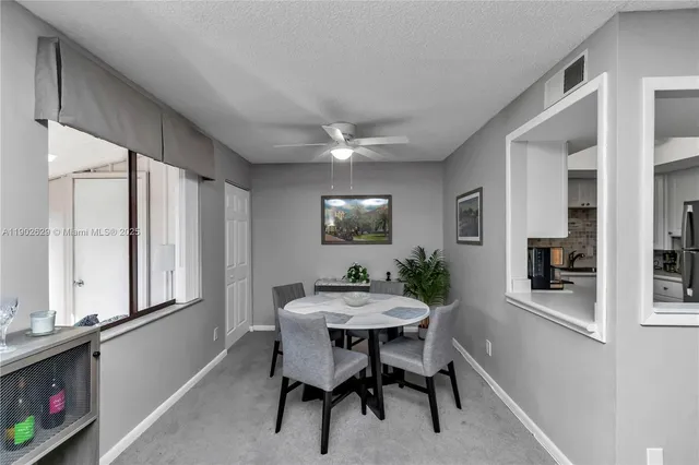 a dining room with furniture and window