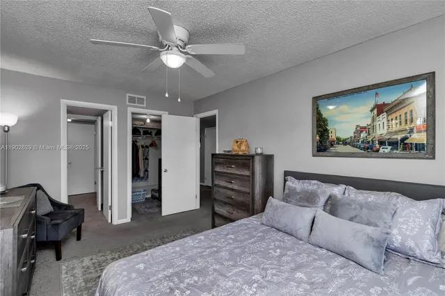 a spacious bedroom with a bed and dresser