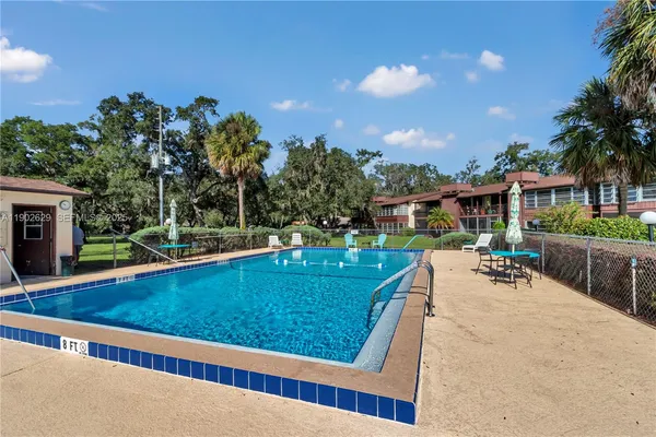 swimming pool view with a seating space and a garden view