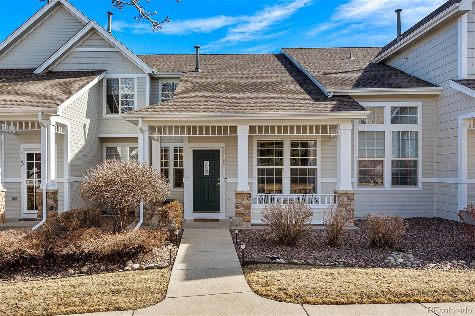 8300 Fairmount Drive, Unit 103 Denver, CO 80247 - Photo 1 of 34 a front view of a house with garden
