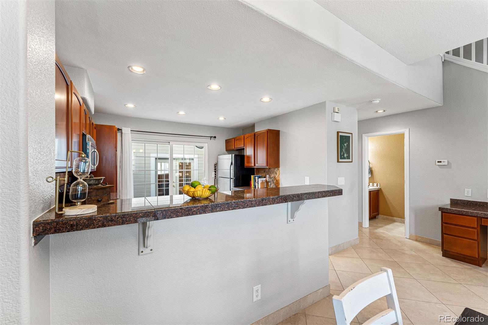 8300 Fairmount Drive, Unit 103 Denver, CO 80247 - Photo 11 of 34 a view of a living room kitchen and a large window