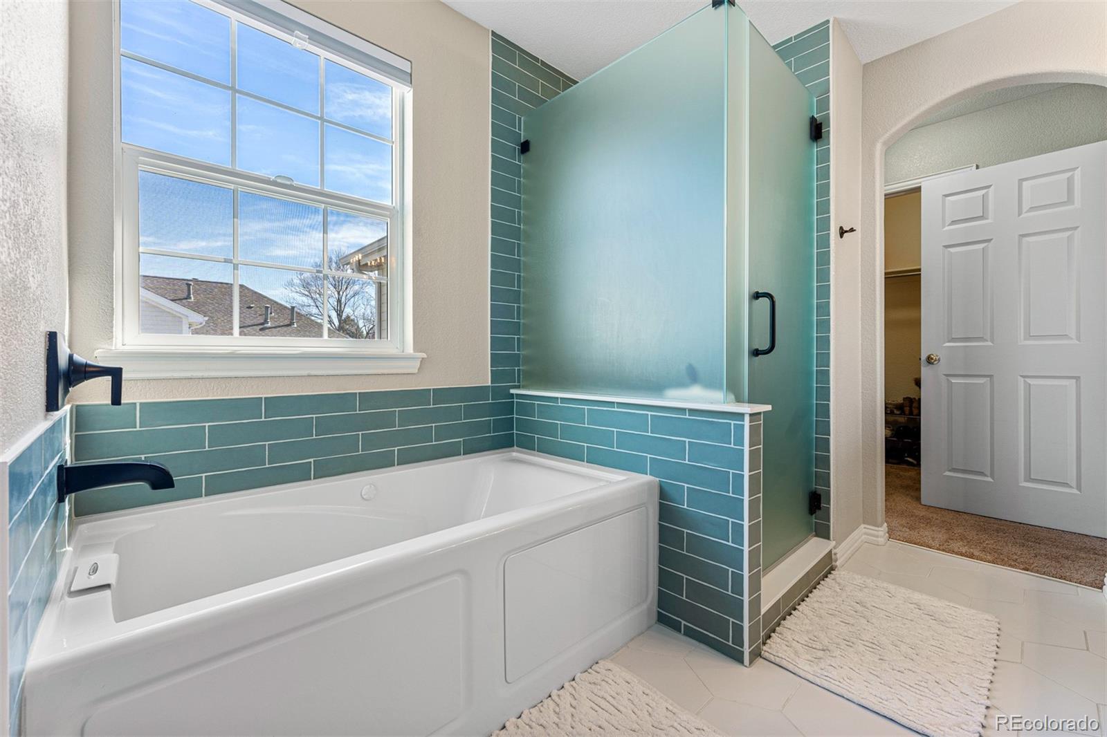 8300 Fairmount Drive, Unit 103 Denver, CO 80247 - Photo 20 of 34 a bathroom with a tub a sink and a window