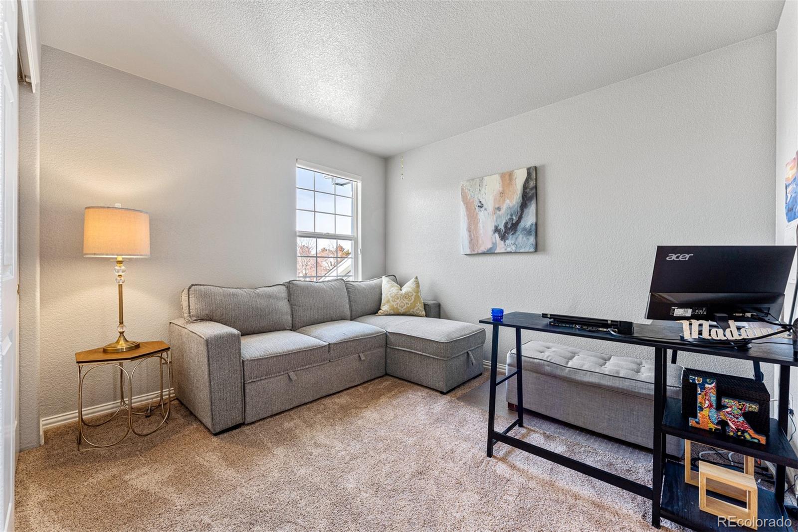 8300 Fairmount Drive, Unit 103 Denver, CO 80247 - Photo 22 of 34 a living room with furniture and a flat screen tv