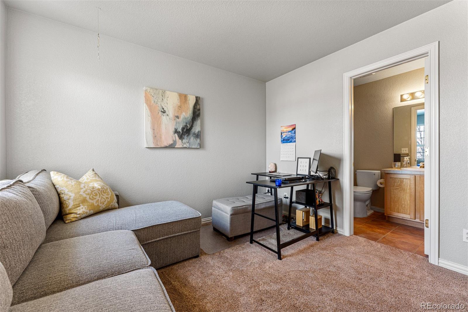 8300 Fairmount Drive, Unit 103 Denver, CO 80247 - Photo 23 of 34 a living room with furniture and a table