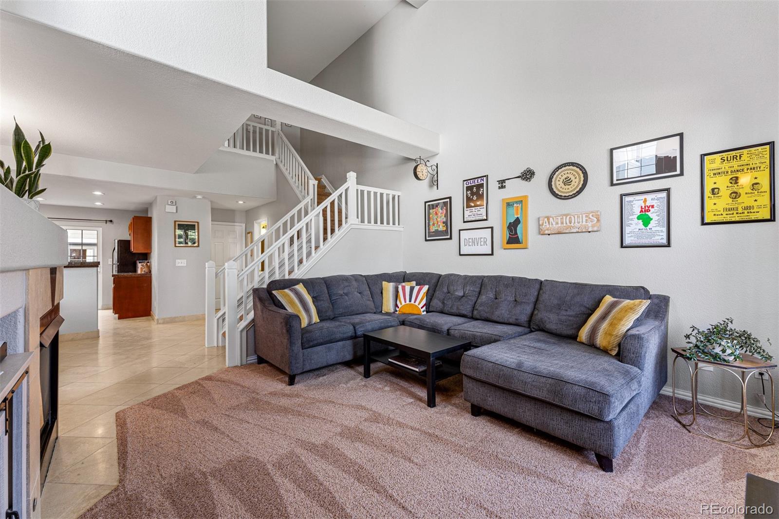 8300 Fairmount Drive, Unit 103 Denver, CO 80247 - Photo 4 of 34 a living room with furniture and a wooden floor
