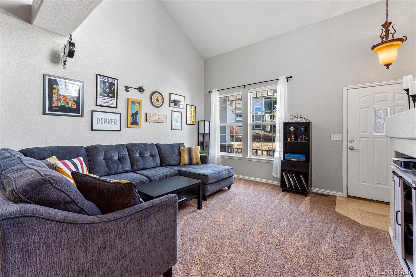8300 Fairmount Drive, Unit 103 Denver, CO 80247 - Photo 5 of 34 a living room with furniture and a flat screen tv