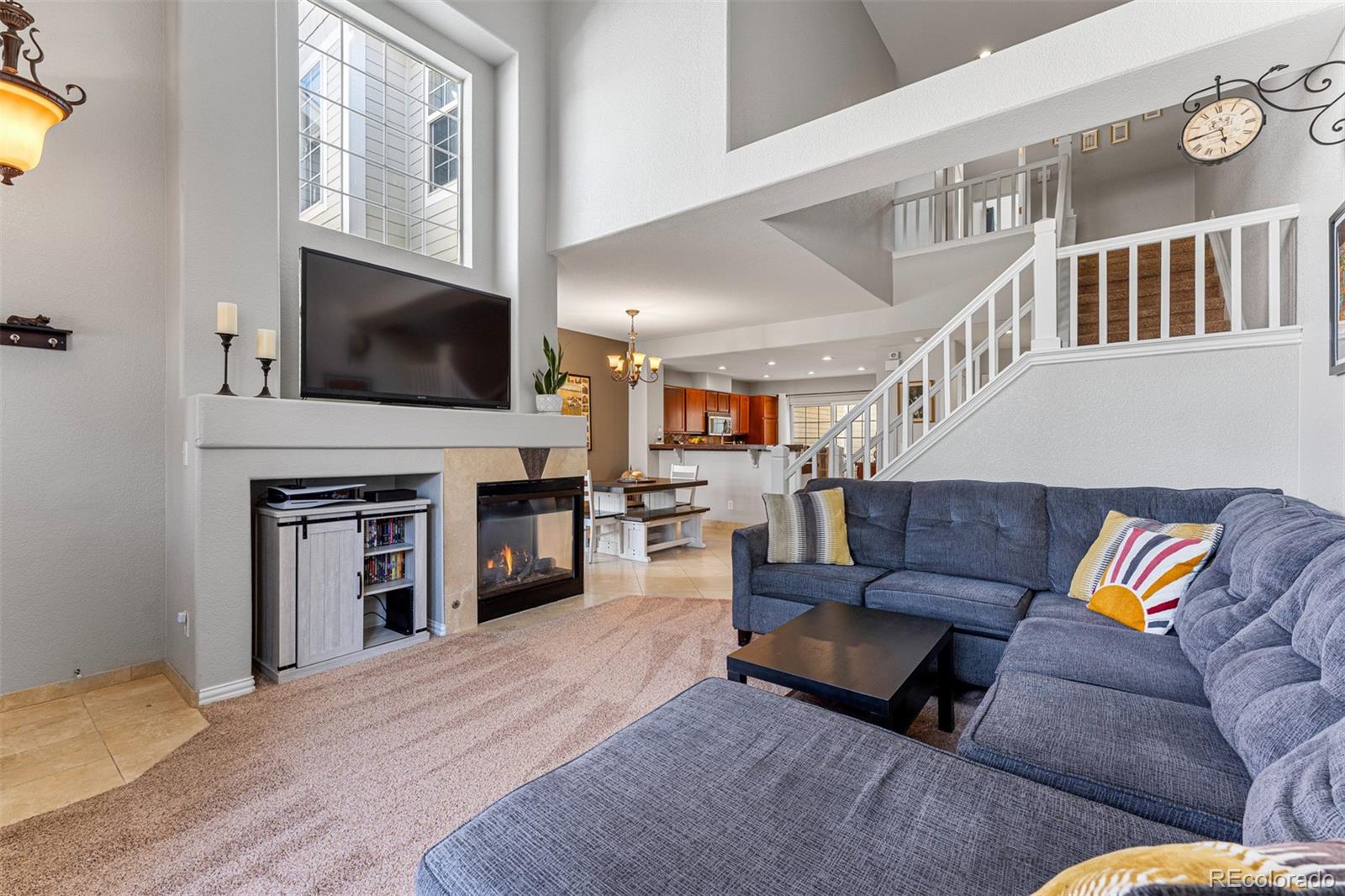 8300 Fairmount Drive, Unit 103 Denver, CO 80247 - Photo 6 of 34 a living room with furniture and a flat screen tv