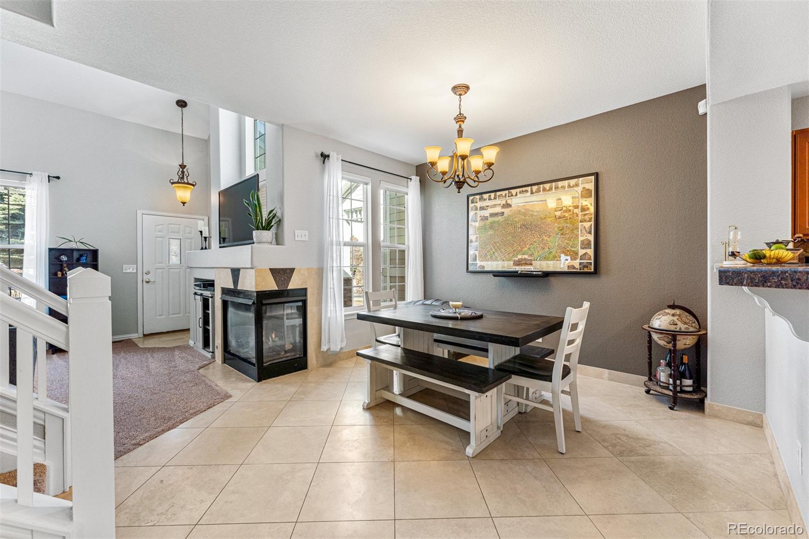 8300 Fairmount Drive, Unit 103 Denver, CO 80247 - Photo 9 of 34 a room with furniture a piano and a flat screen tv