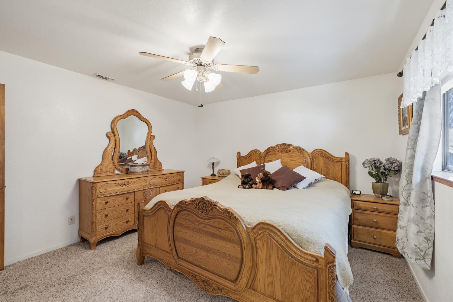 4838 Golden Street Pollock Pines, CA 95726 - Photo 13 of 35 a bedroom with a bed and a chandelier