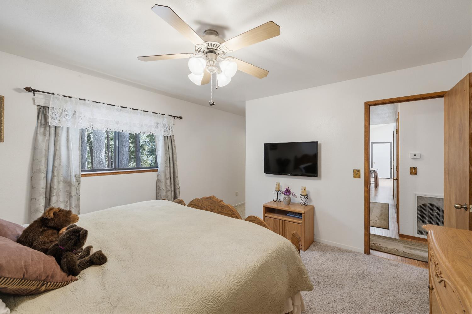 4838 Golden Street Pollock Pines, CA 95726 - Photo 14 of 35 a bedroom with a bed and a flat screen tv