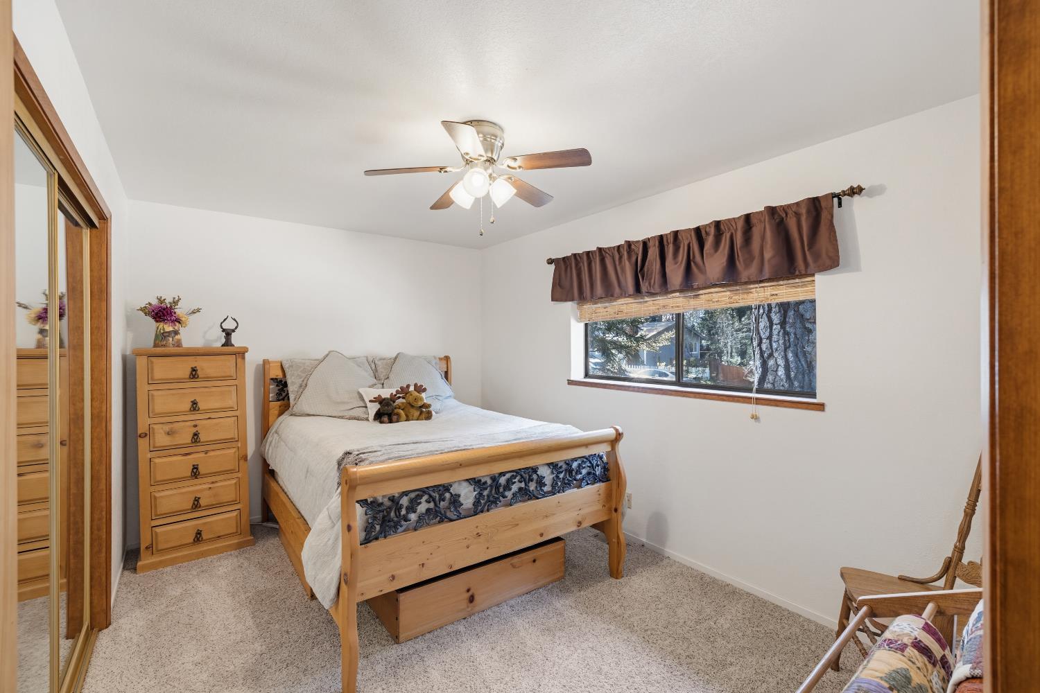 4838 Golden Street Pollock Pines, CA 95726 - Photo 16 of 35 a bedroom with a bed and a chandelier