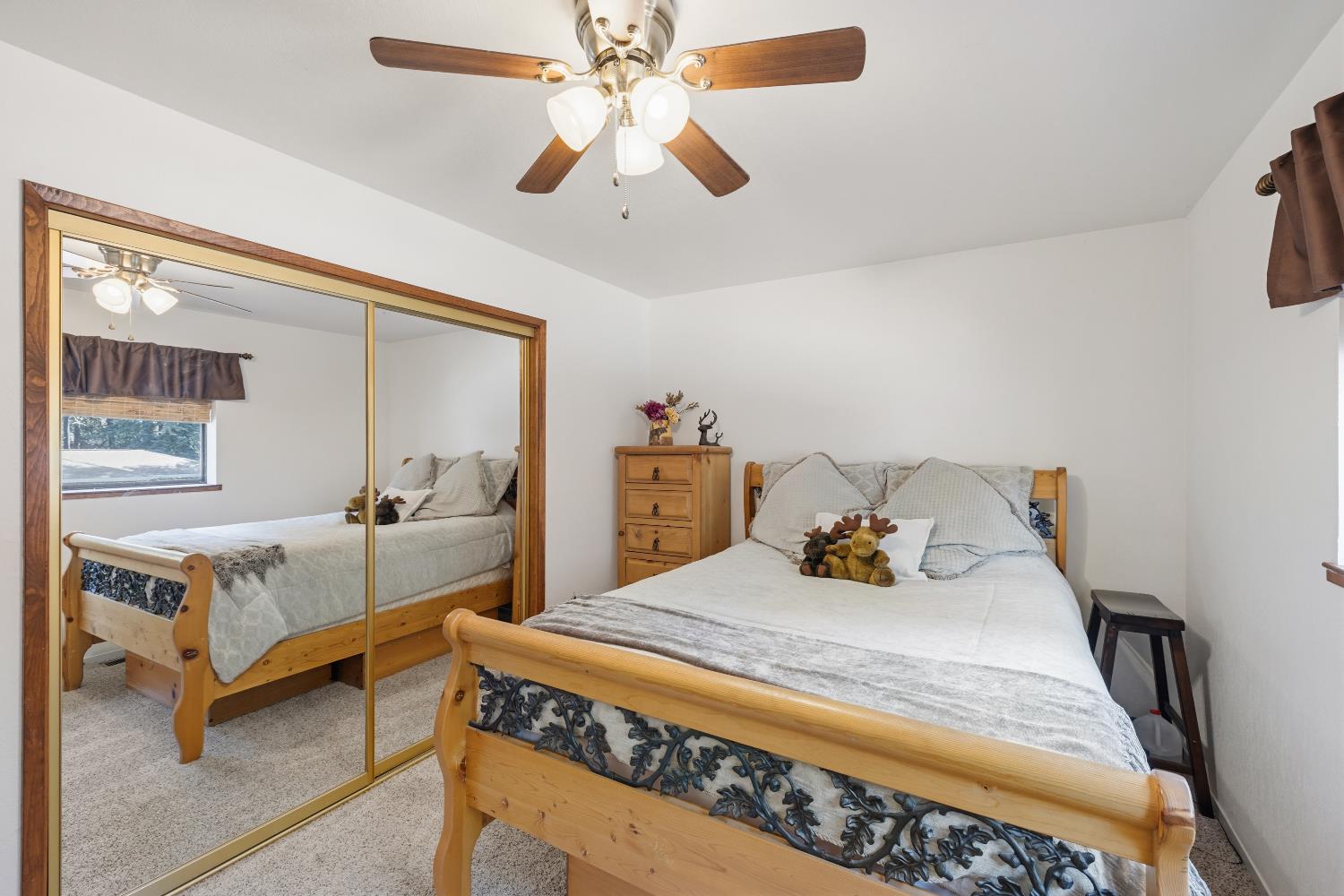 4838 Golden Street Pollock Pines, CA 95726 - Photo 17 of 35 a bedroom with a bed and a chandelier