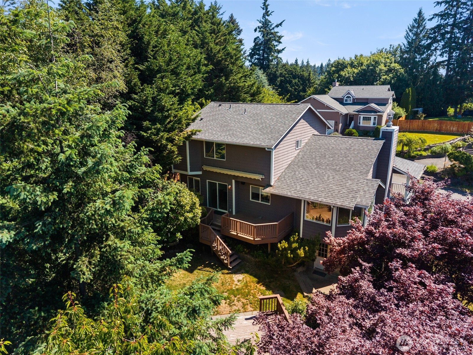 26227 Montera Loop Northeast Kingston, WA 98346 - Photo 3 of 22 a aerial view of a house with yard and trees around
