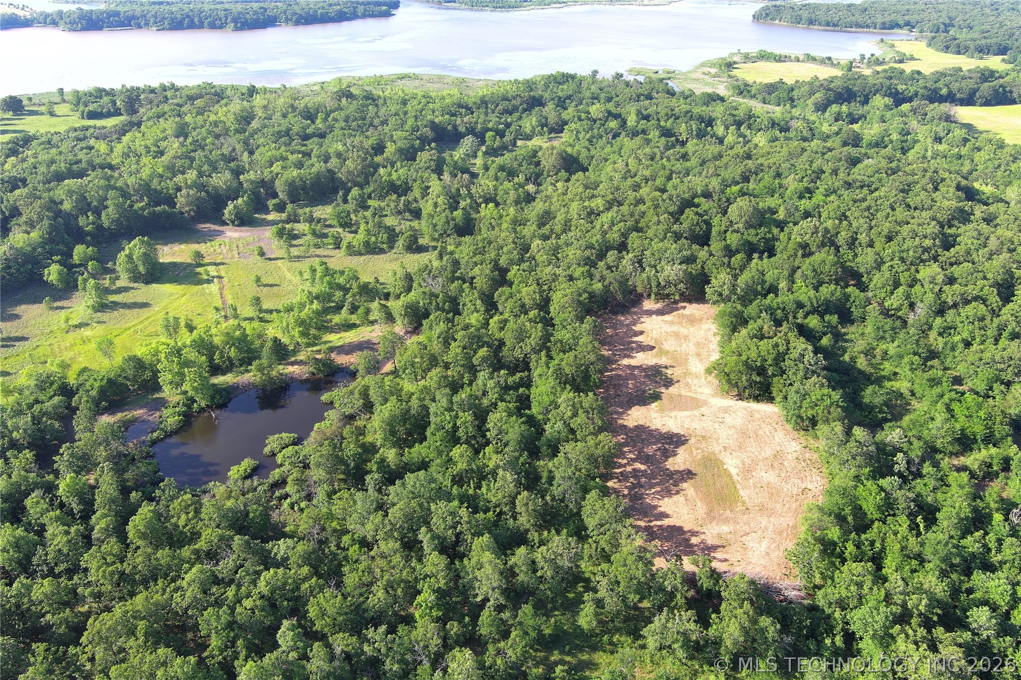 20862 East 1160th Road Keota, OK 74941 - Photo 7 of 47 Expansive wooded acreage featuring a natural pond, cleared sections, and varied tree coverage