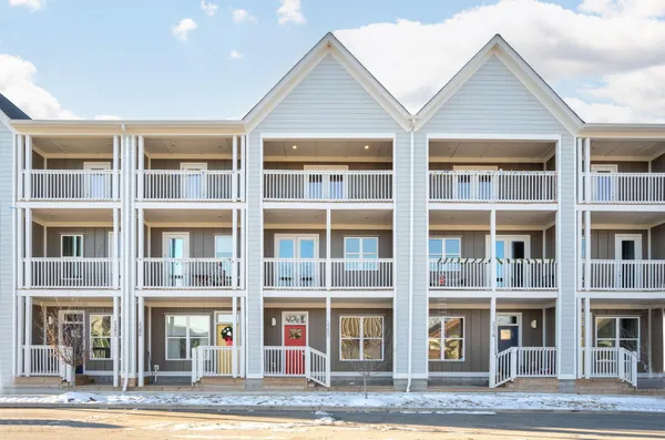 a view of a brick building next to a yard