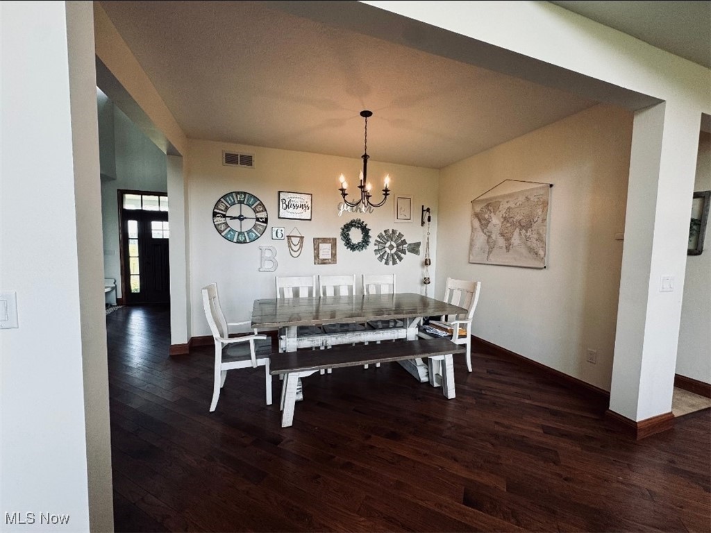 49402 Patton Road Jerusalem, OH 43747 - Photo 22 of 28 Dining space with dark wood-type flooring and a chandelier