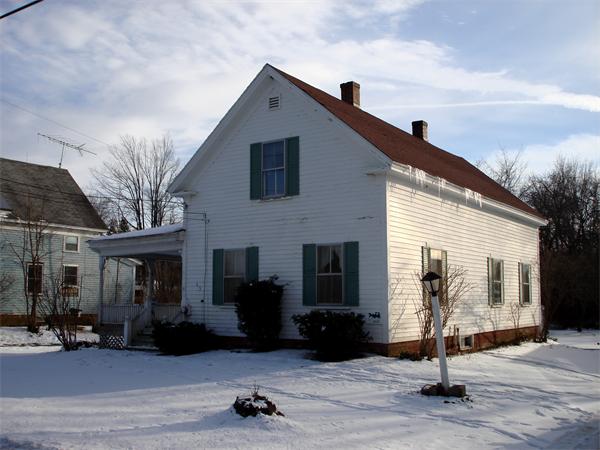 a front view of a house with parking area