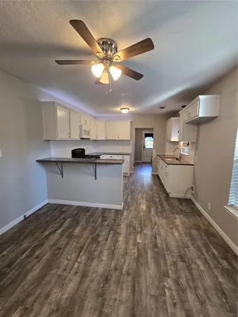 a kitchen with kitchen island a sink stainless steel appliances and cabinets