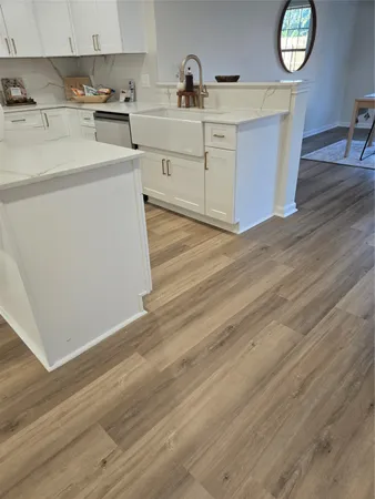 a kitchen with cabinets a sink and appliances