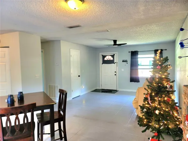 a dining room with furniture and window