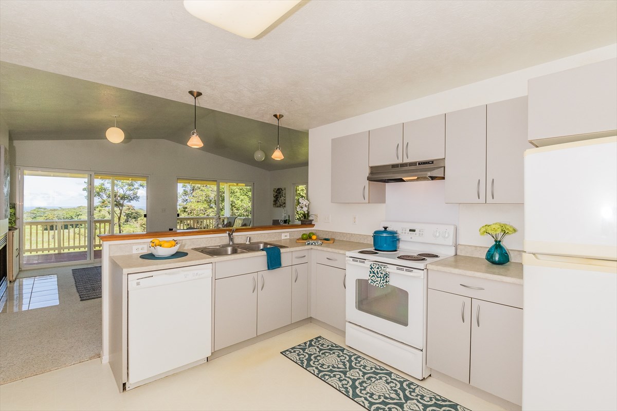455 Akolea Road Hilo, HI 96720 - Photo 15 of 29 a kitchen with a sink a stove and cabinets