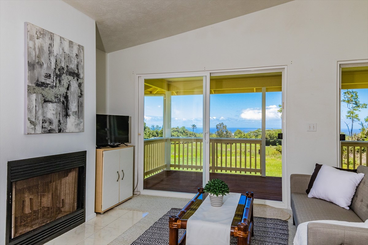 455 Akolea Road Hilo, HI 96720 - Photo 8 of 29 a living room with furniture a flat screen tv and a fireplace