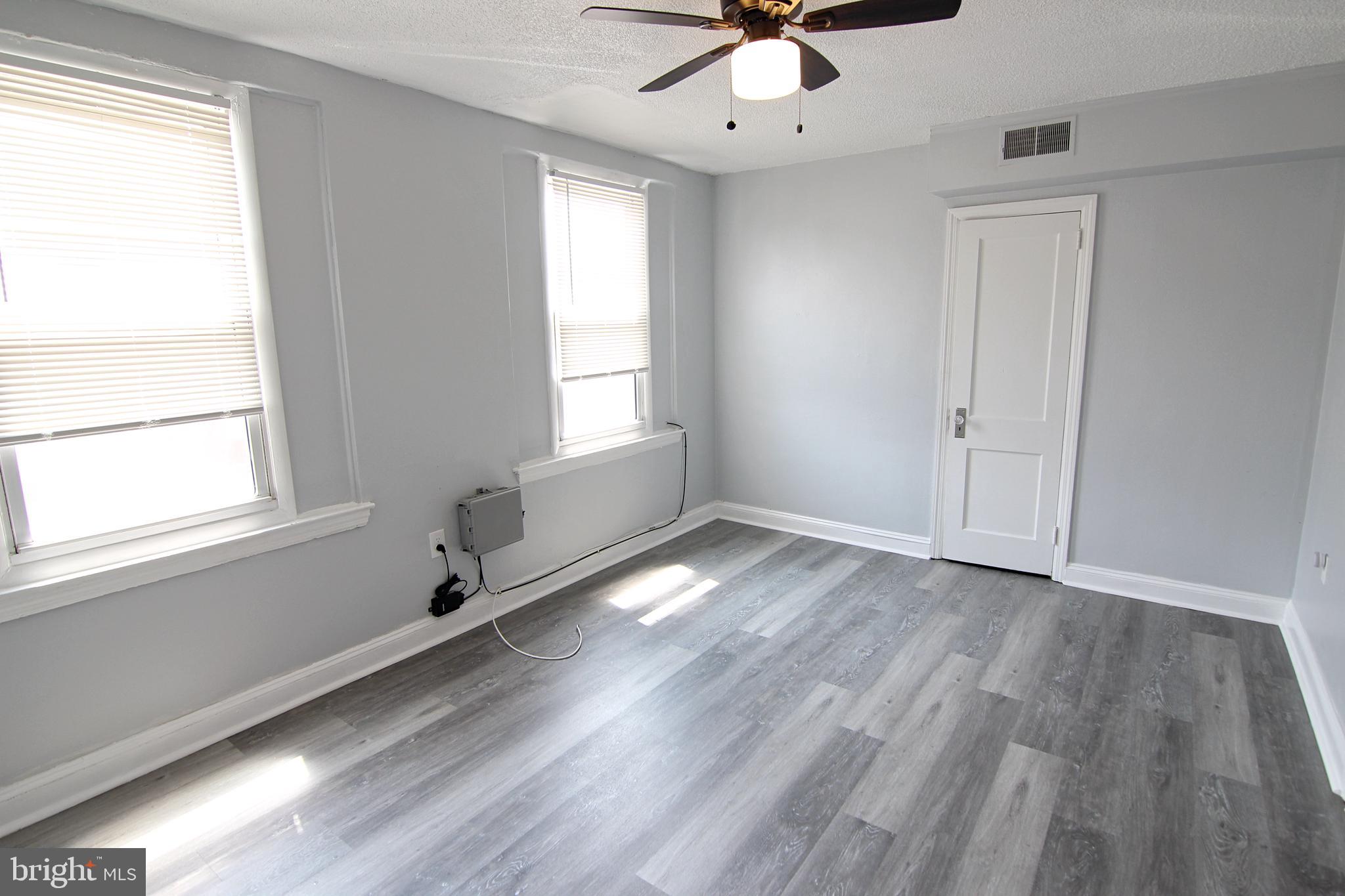 135 West 4th Street, Unit 2E Bridgeport, PA 19405 - Photo 2 of 11 a view of an empty room with a window and wooden floor