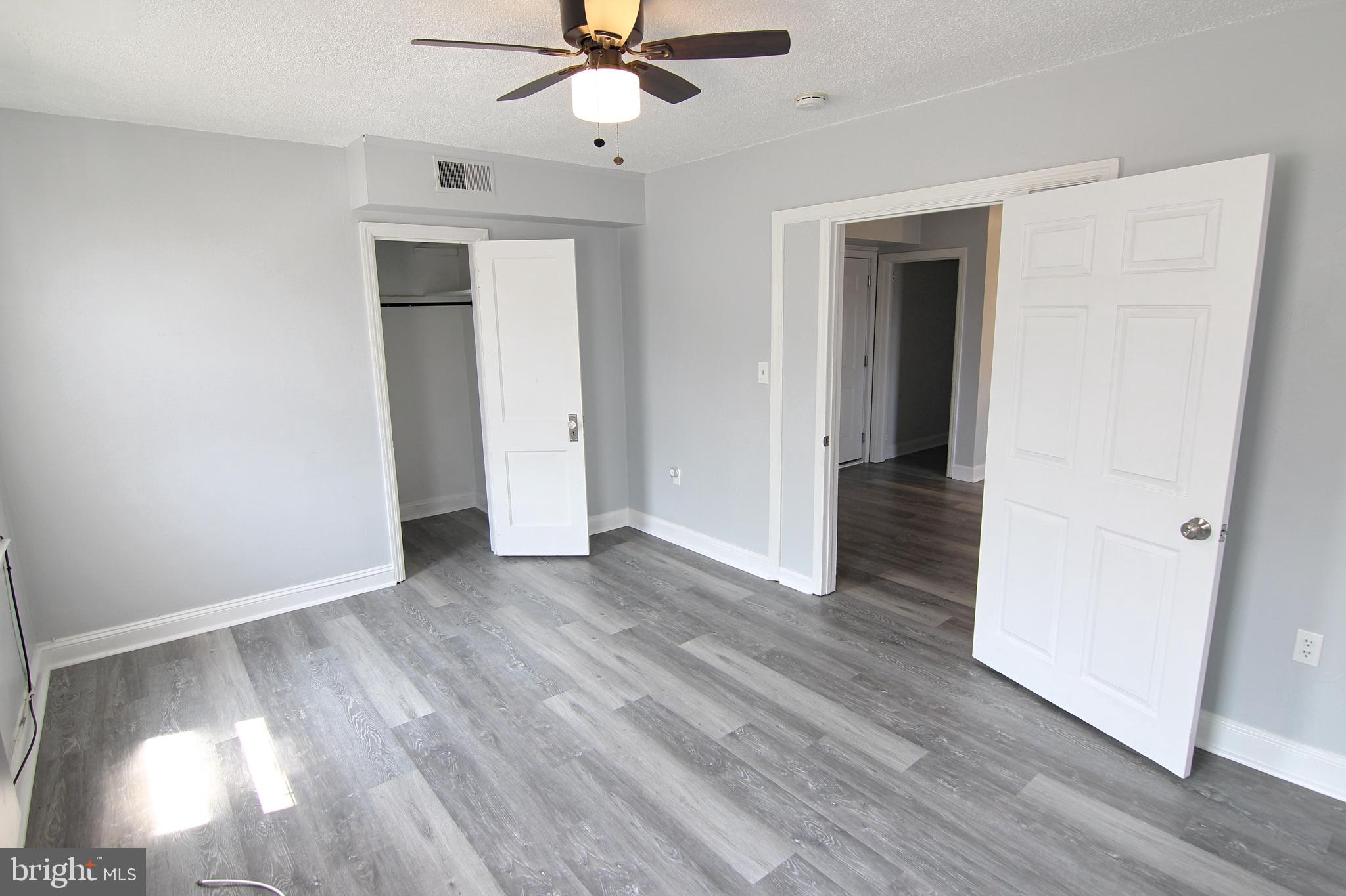 135 West 4th Street, Unit 2E Bridgeport, PA 19405 - Photo 3 of 11 a view of a livingroom with wooden floor and a ceiling fan