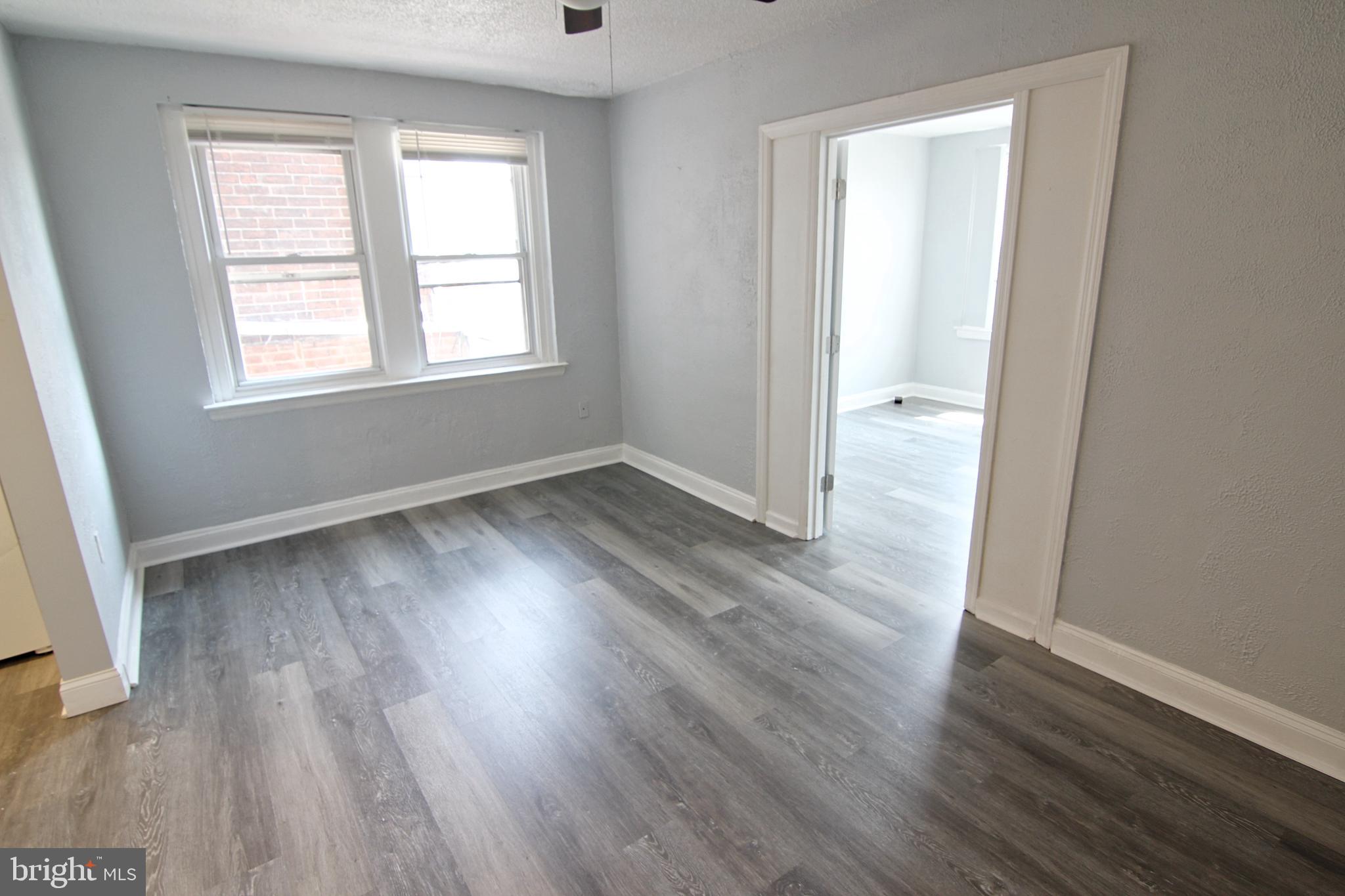 135 West 4th Street, Unit 2E Bridgeport, PA 19405 - Photo 4 of 11 an empty room with wooden floor and windows