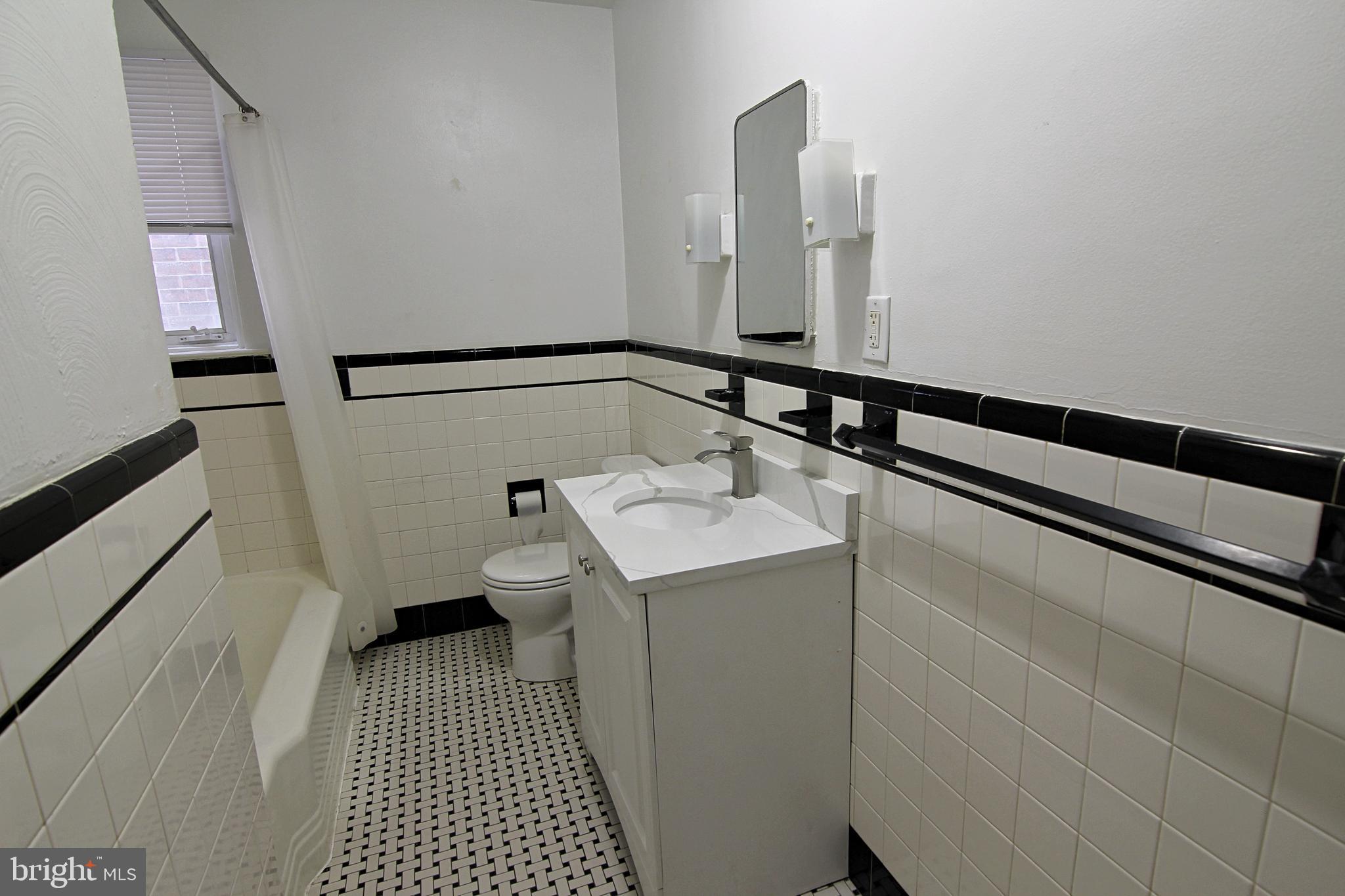 135 West 4th Street, Unit 2E Bridgeport, PA 19405 - Photo 8 of 11 a bathroom with a sink and a mirror
