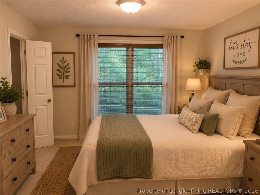 1833 Sardonyx Road, Unit 3 Fayetteville, NC 28303 - Photo 5 of 10 a bedroom with a large bed and a window
