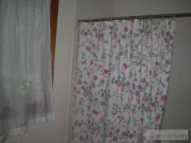 1088 Sugarloaf Road Boone, NC 28607 - Photo 5 of 8 a bathroom with a shower curtain and a curtain