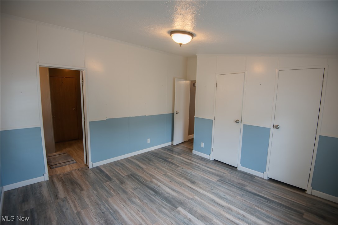 4594 Center Road Andover, OH 44003 - Photo 16 of 39 Unfurnished bedroom featuring wood finished floors and a textured ceiling