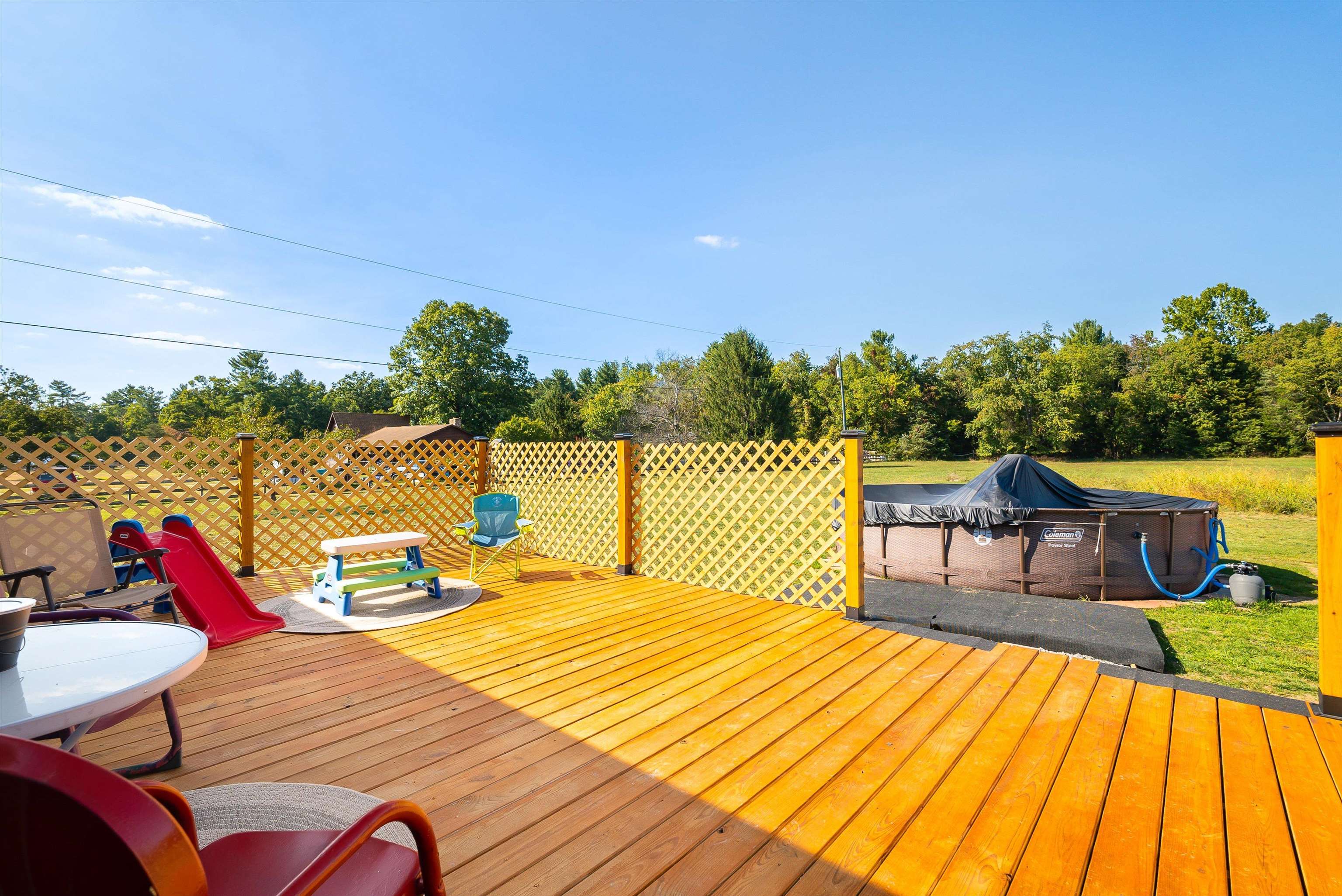 468 Paine Run Road Grottoes, VA 24441 - Photo 21 of 31 a view of deck that has couches and table with wooden floor and fence