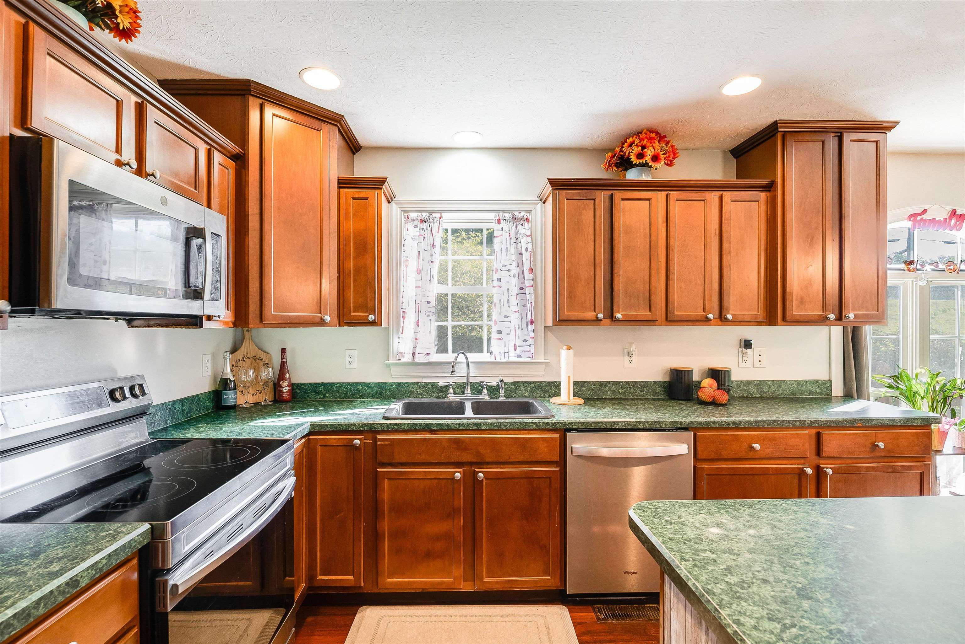 468 Paine Run Road Grottoes, VA 24441 - Photo 10 of 31 a kitchen with stainless steel appliances granite countertop a sink a stove counter space and cabinets