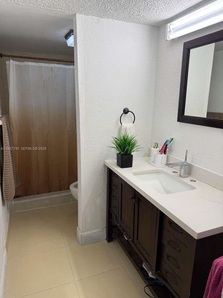 1900 West 68th Street, Unit A205 Hialeah, FL 33014 - Photo 2 of 6 a bathroom with a sink and a mirror
