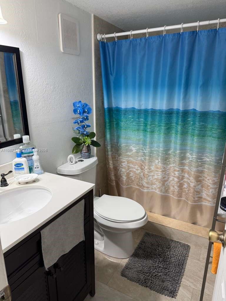 1900 West 68th Street, Unit A205 Hialeah, FL 33014 - Photo 3 of 6 a bathroom with a sink toilet and a mirror