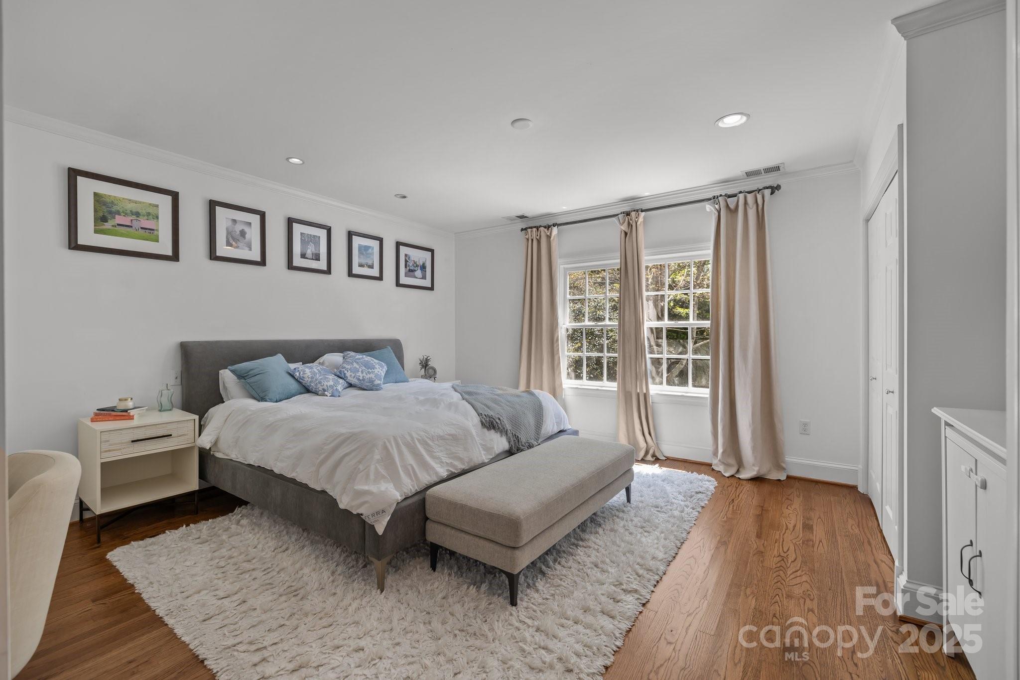 3019 Sunset Drive Charlotte, NC 28209 - Photo 13 of 46 a spacious bedroom with a bed a couch and a window