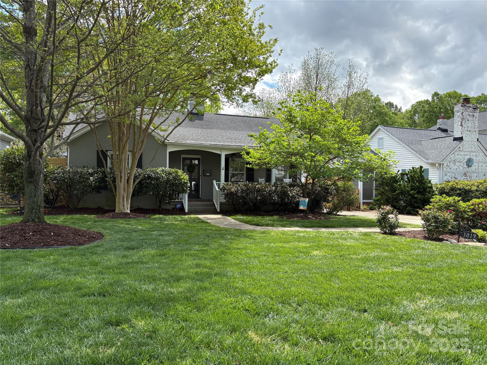 3019 Sunset Drive Charlotte, NC 28209 - Photo 2 of 46 a front view of a house with a garden and trees