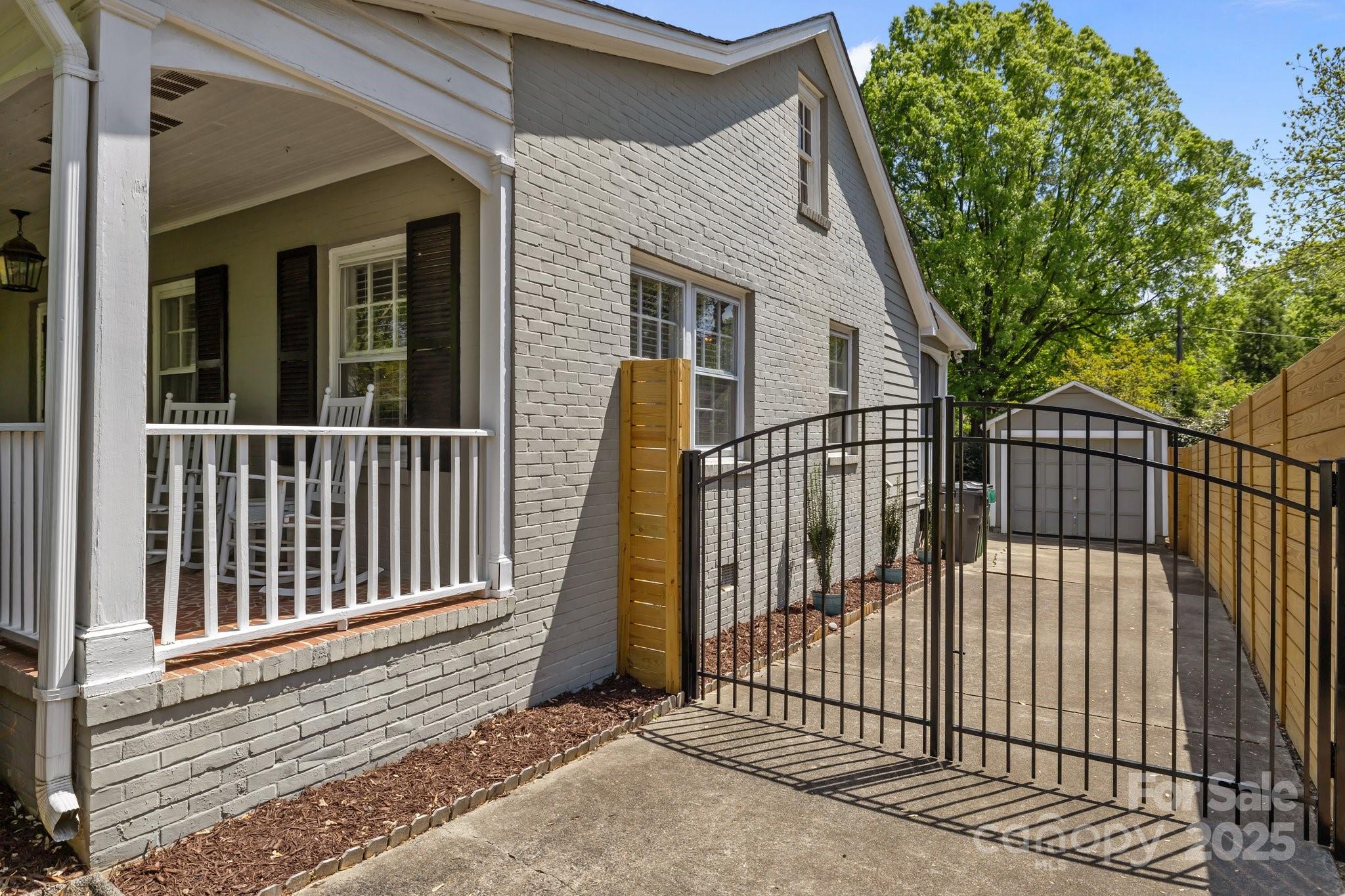 3019 Sunset Drive Charlotte, NC 28209 - Photo 38 of 46 a view of a house with a small yard and wooden fence