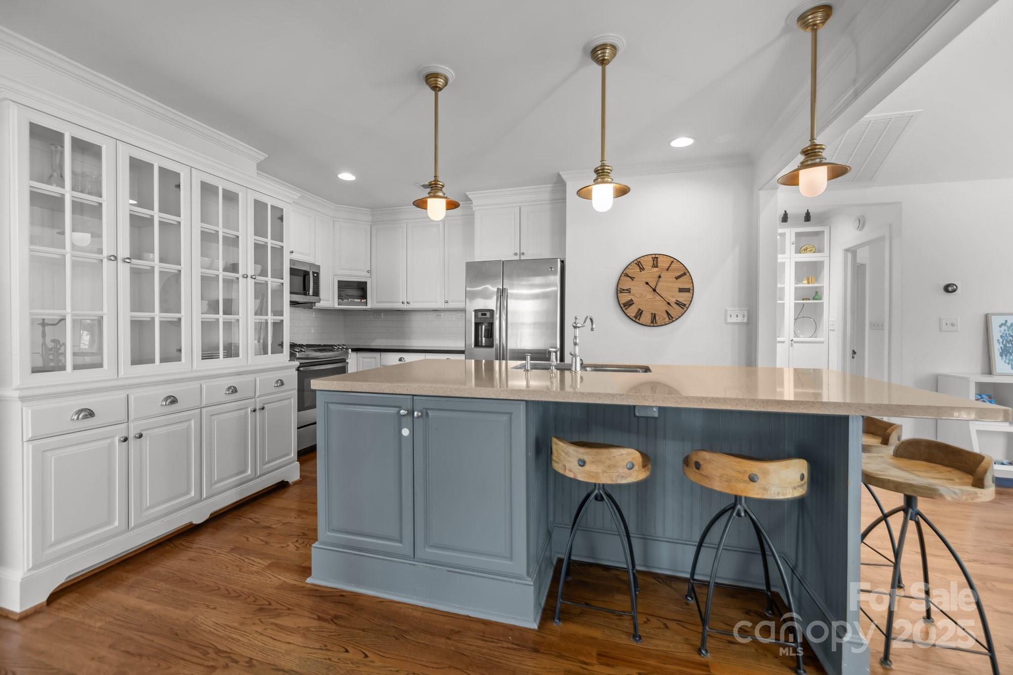 3019 Sunset Drive Charlotte, NC 28209 - Photo 6 of 46 a kitchen with stainless steel appliances granite countertop a stove a sink dishwasher a dining table and chairs with wooden floor