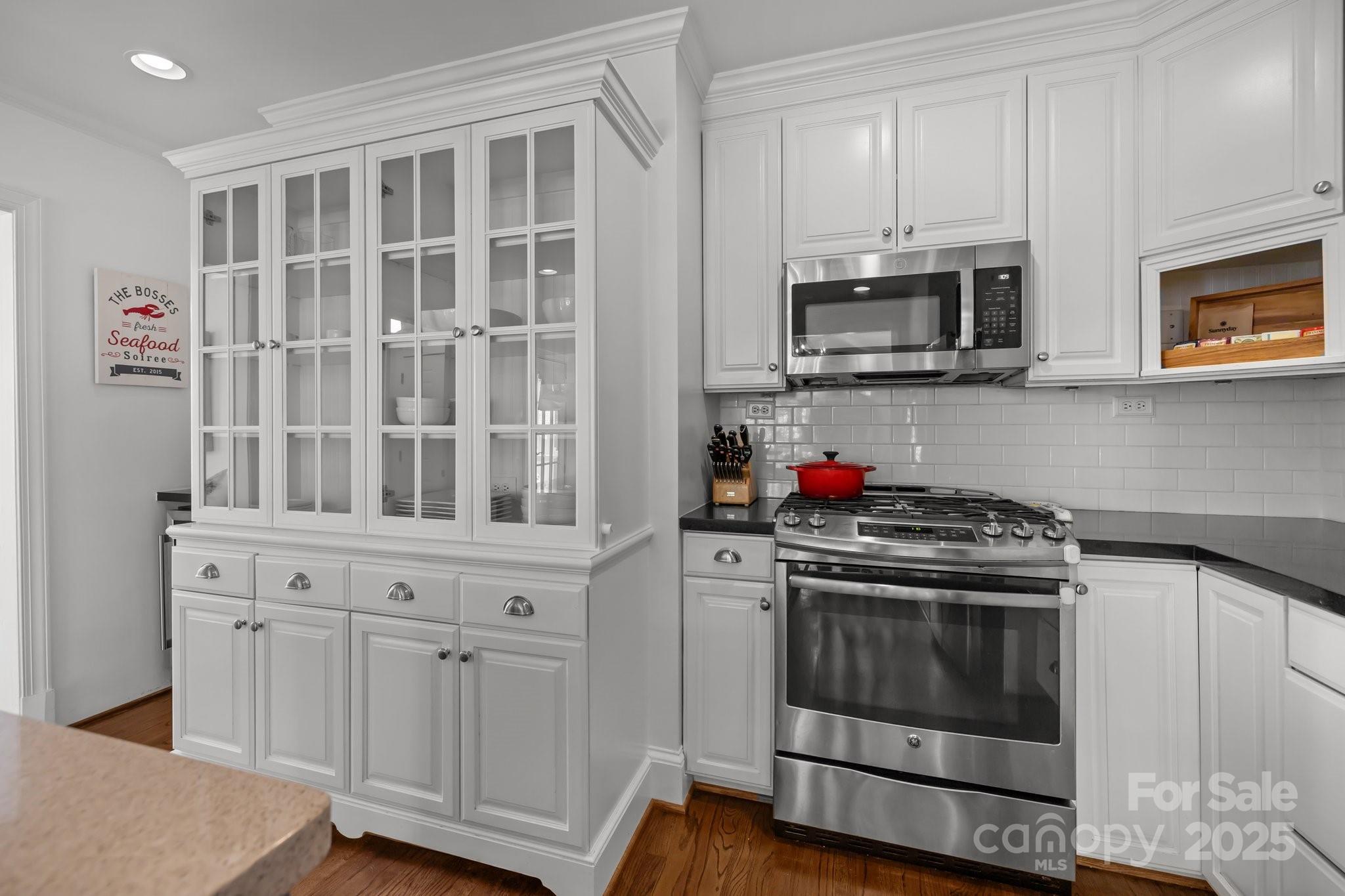 3019 Sunset Drive Charlotte, NC 28209 - Photo 8 of 46 a kitchen with stainless steel appliances granite countertop white cabinets and a stove top oven