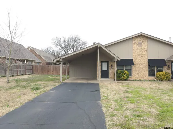 a view of a house with a yard and garage