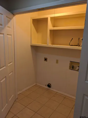 a view of storage and utility room with a window